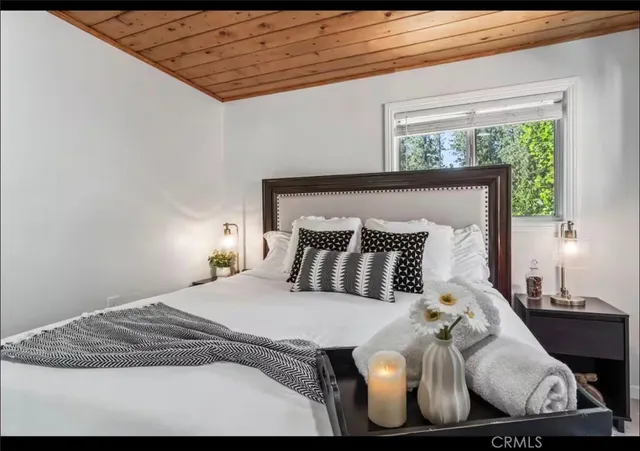 a bed sitting in a bedroom next to a window