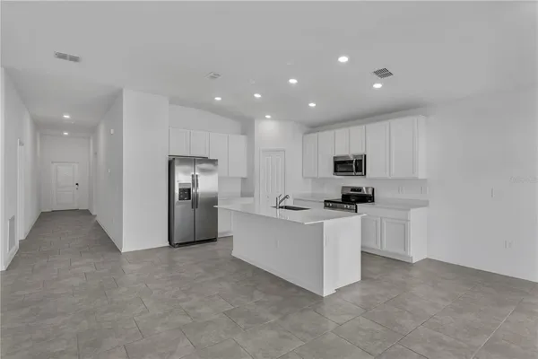 a kitchen with stainless steel appliances a refrigerator sink and stove