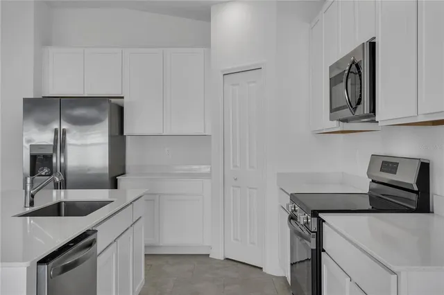 a kitchen with a sink and a refrigerator