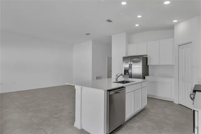 a kitchen that has a sink and a stove