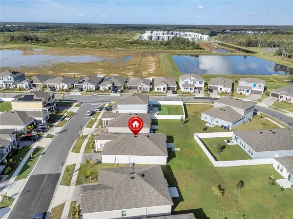an aerial view of a house with a ocean