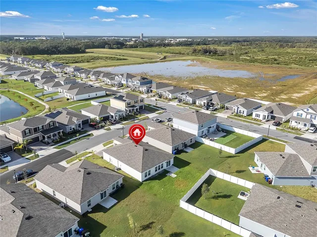 an aerial view of residential building and lake