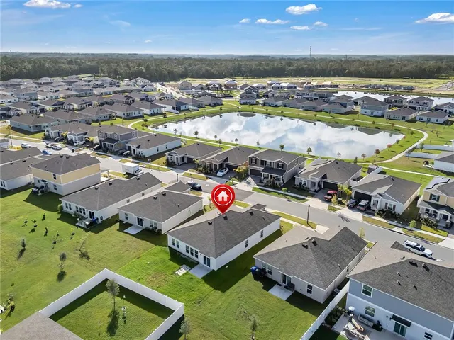 an aerial view of a house with a ocean view
