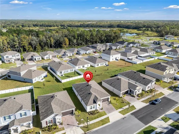 an aerial view of residential houses with outdoor space