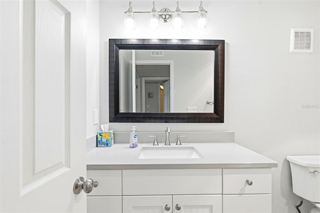 14800 Walsingham Road, Unit 702 Largo, FL 33774 - Photo 33 of 42 a bathroom with a sink and a mirror