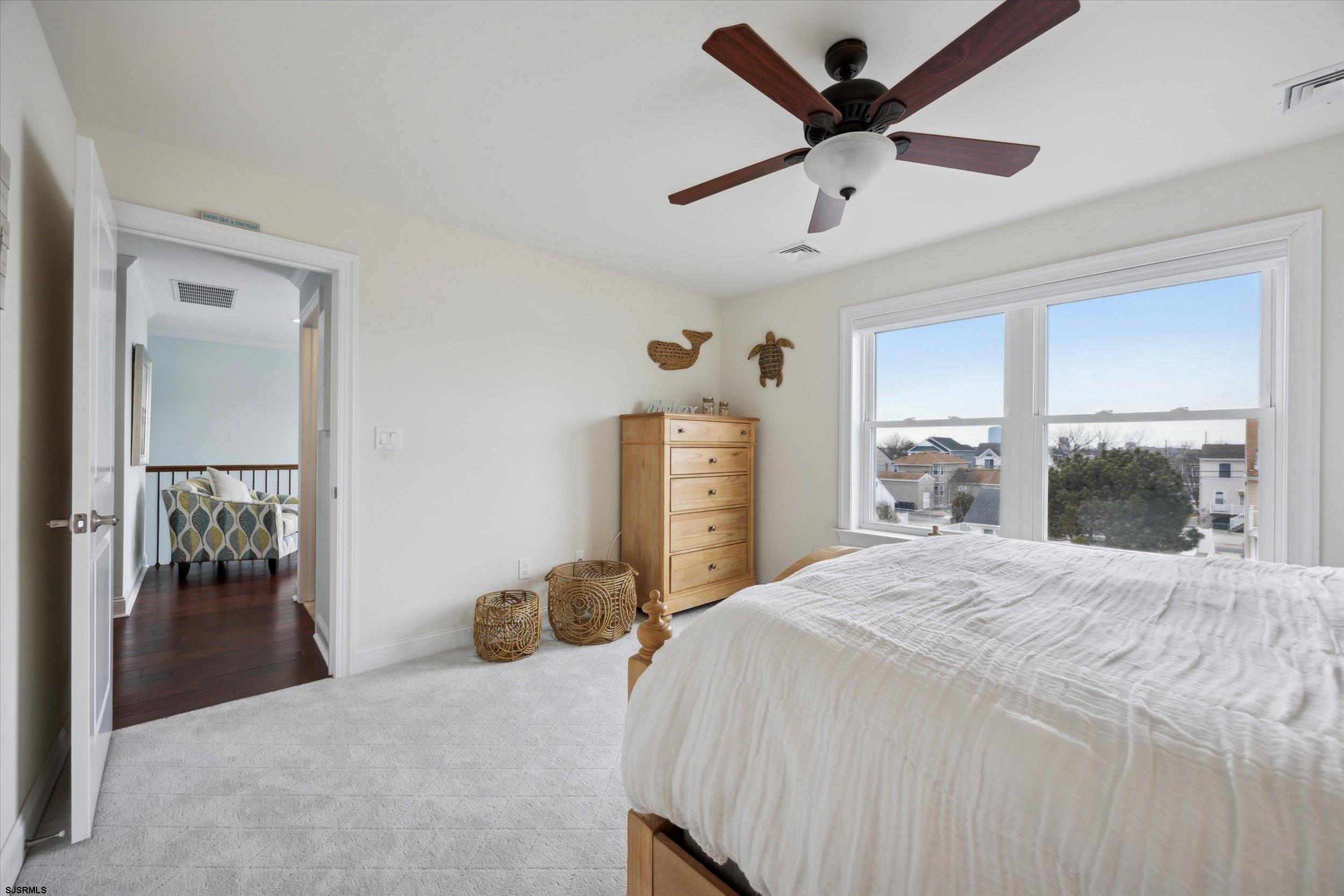 235 35th Street South Brigantine, NJ 08203 - Photo 11 of 56 a bedroom with a bed and a large mirror