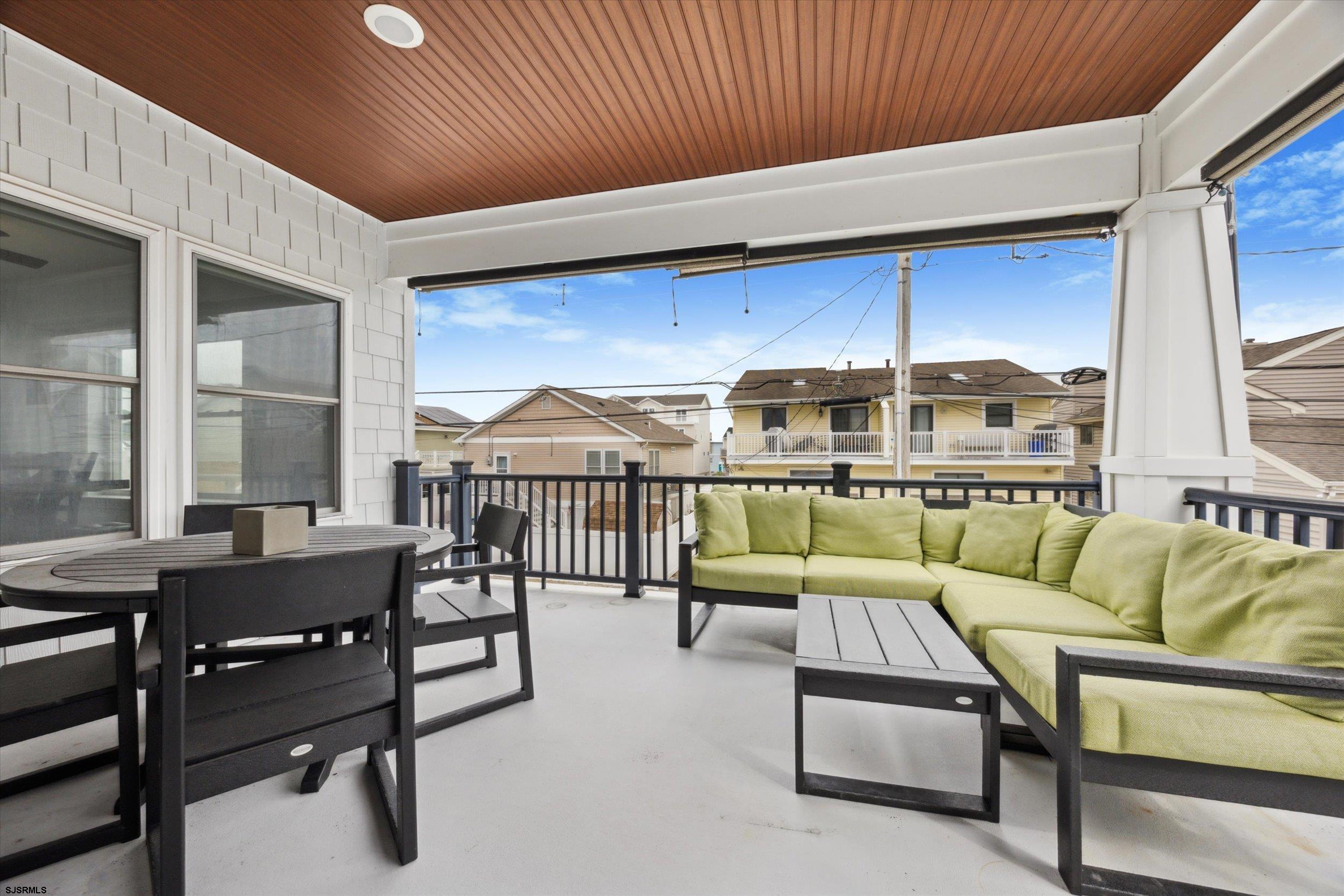 235 35th Street South Brigantine, NJ 08203 - Photo 14 of 56 a living room with furniture a floor to ceiling window and a table