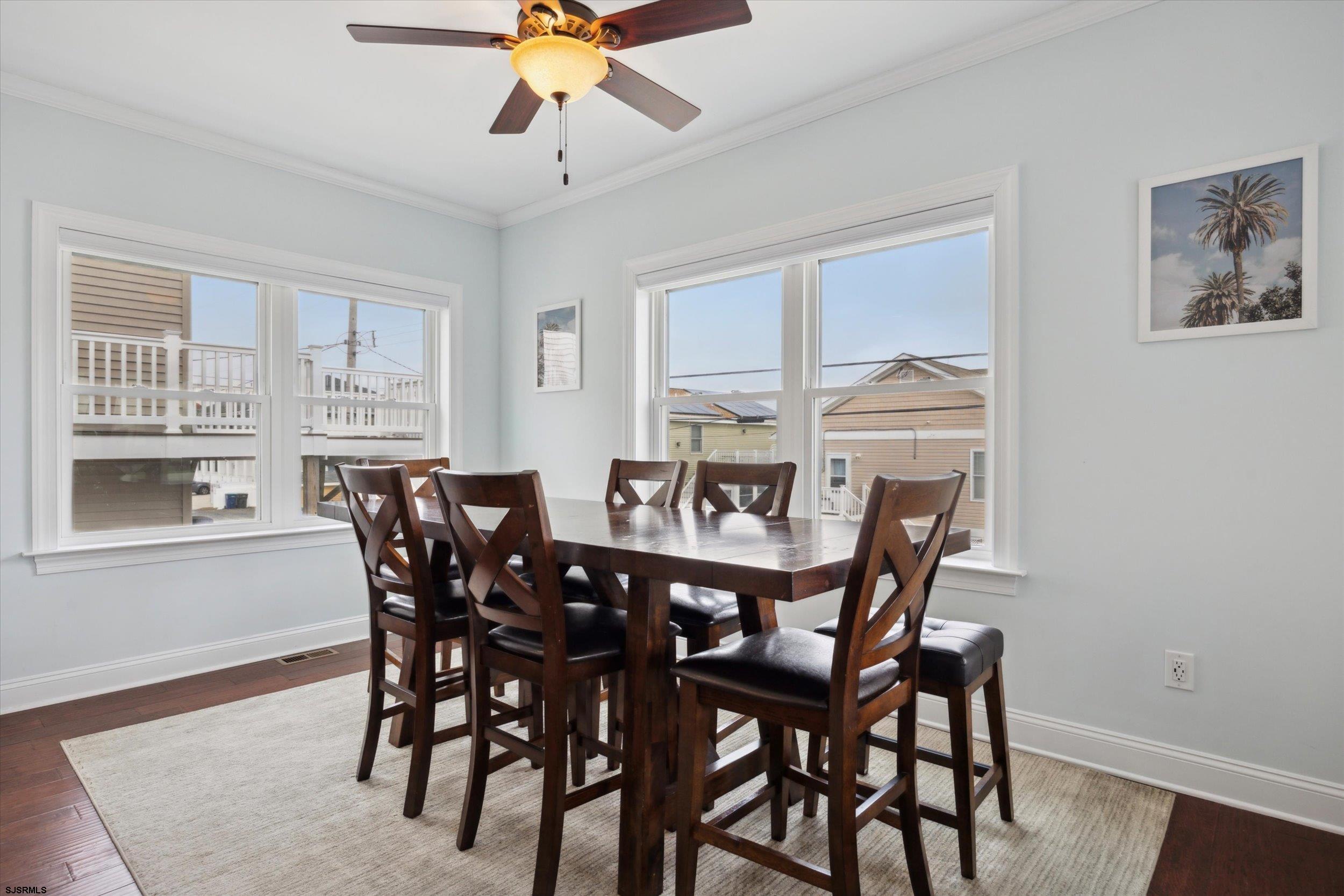 235 35th Street South Brigantine, NJ 08203 - Photo 15 of 56 a view of a dining room with furniture and wooden floor