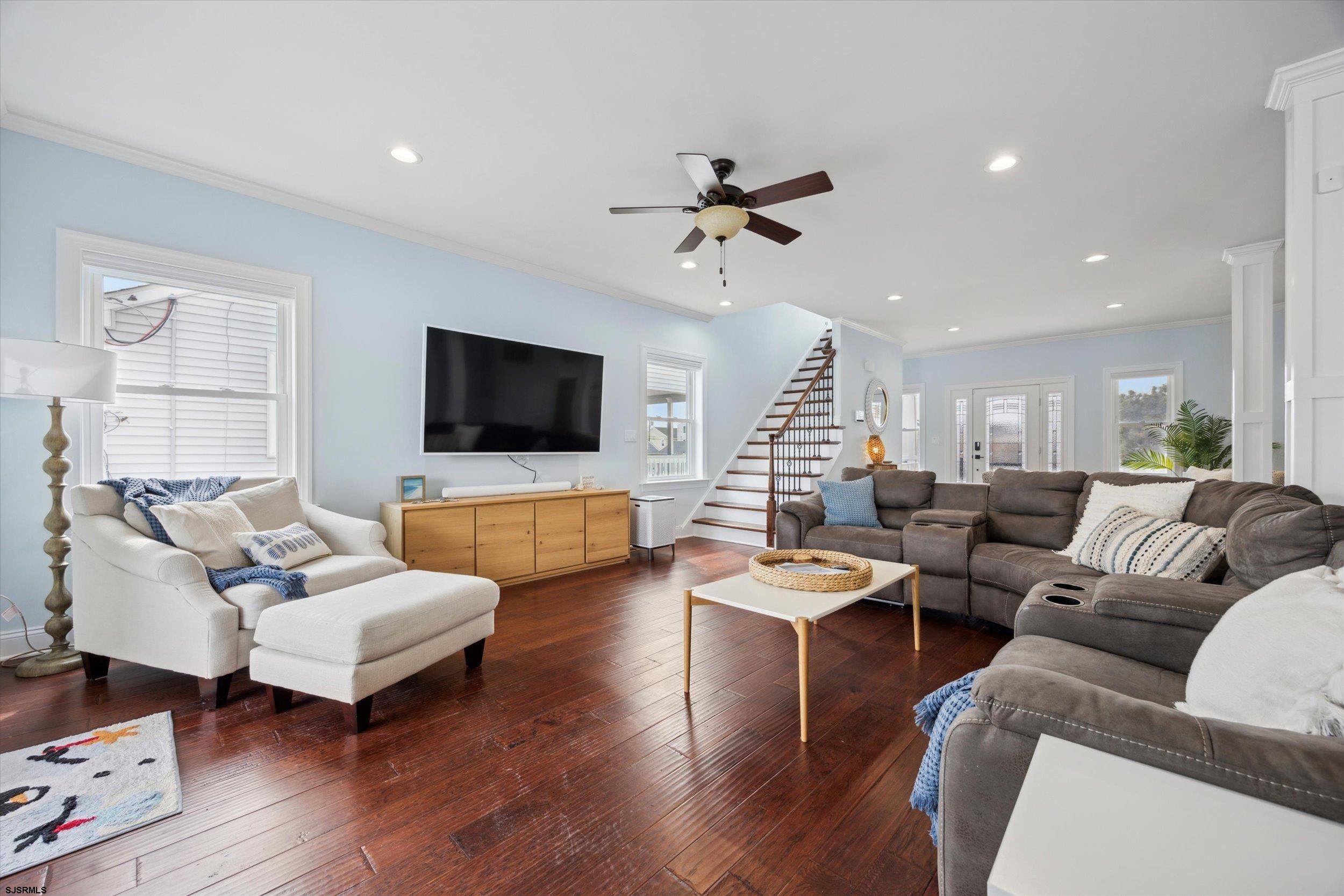 235 35th Street South Brigantine, NJ 08203 - Photo 19 of 56 a living room with furniture flat screen tv and wooden floor