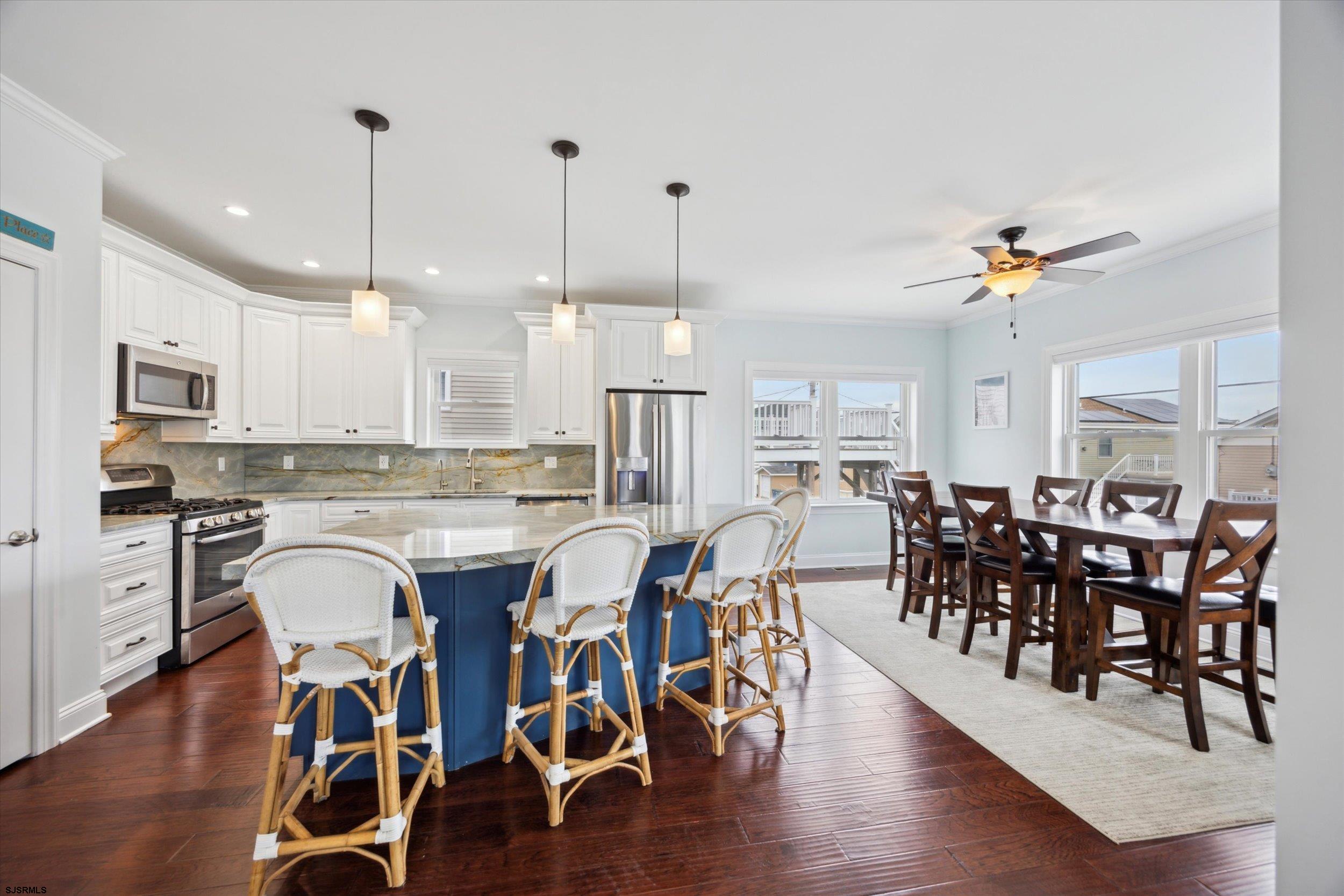 235 35th Street South Brigantine, NJ 08203 - Photo 21 of 56 a view of a a dining room with furniture window and wooden floor