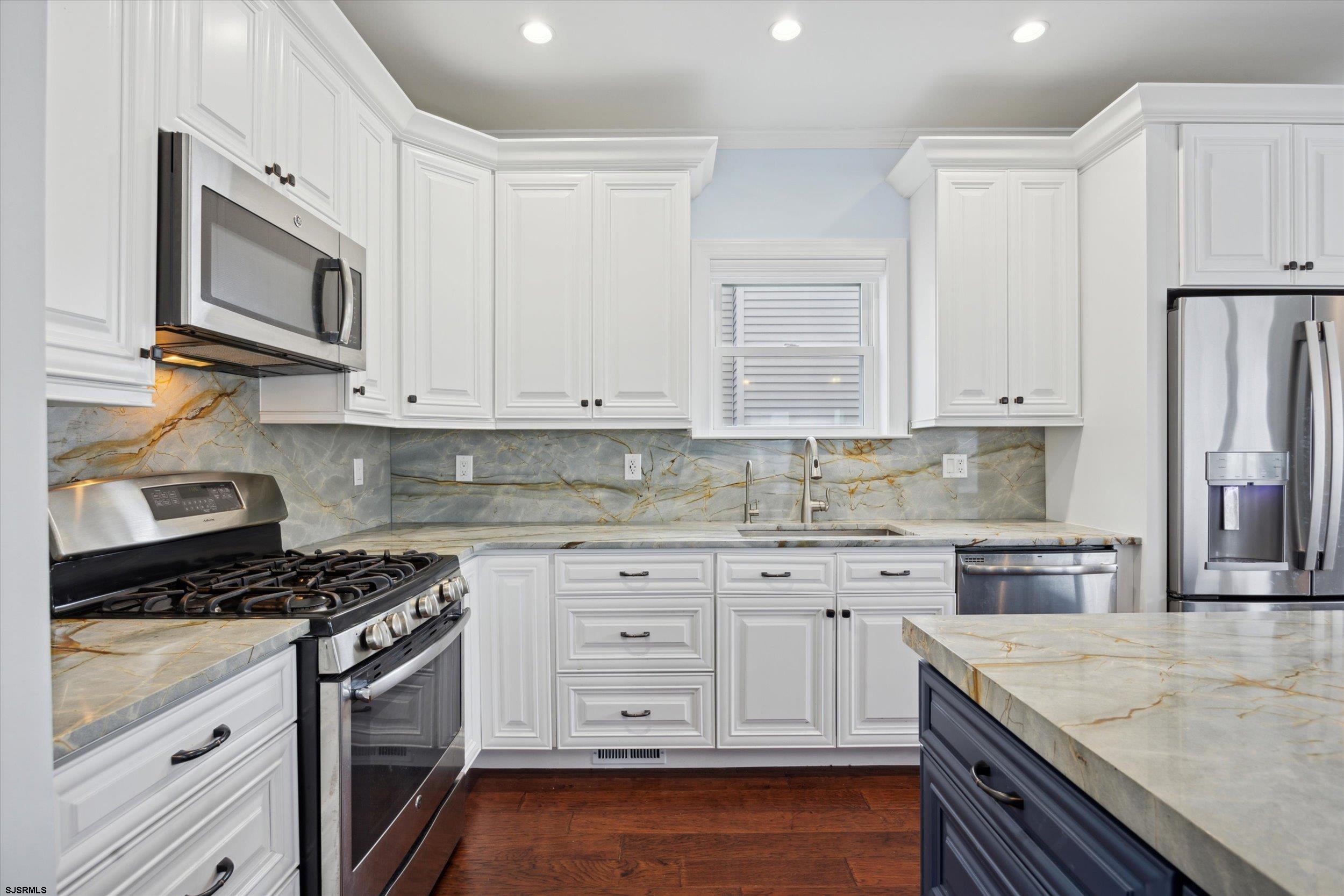 235 35th Street South Brigantine, NJ 08203 - Photo 23 of 56 a kitchen with stainless steel appliances granite countertop a sink stove and microwave