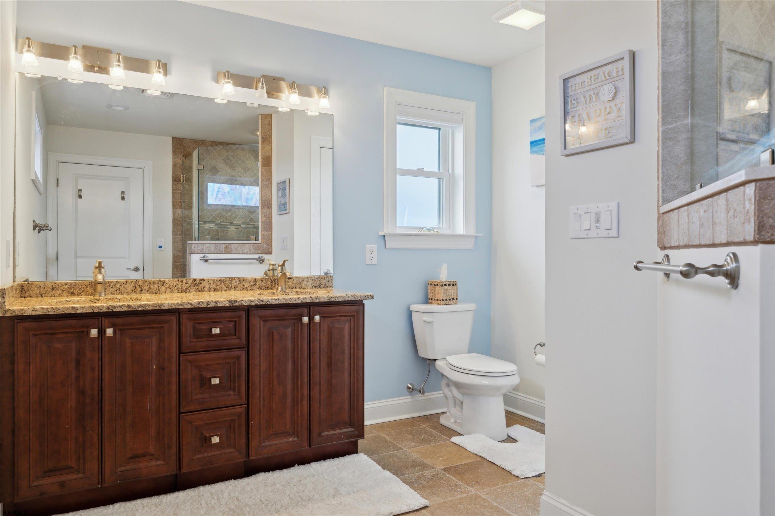 235 35th Street South Brigantine, NJ 08203 - Photo 24 of 56 a bathroom with a granite countertop toilet sink and mirror