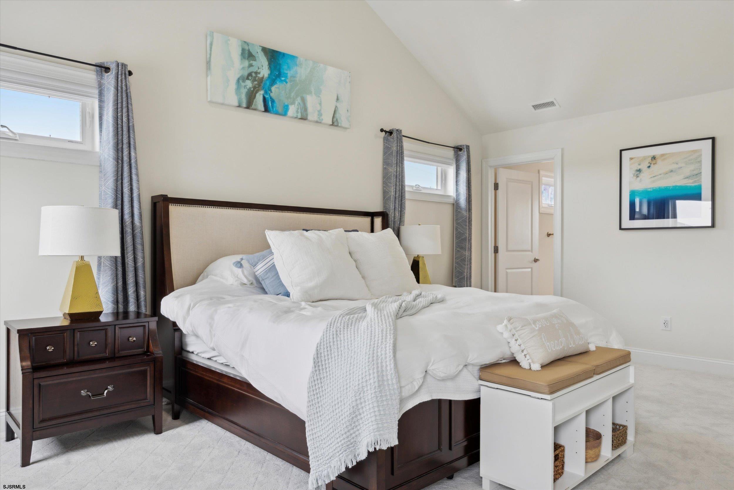 235 35th Street South Brigantine, NJ 08203 - Photo 27 of 56 a bedroom with a bed and wooden floor