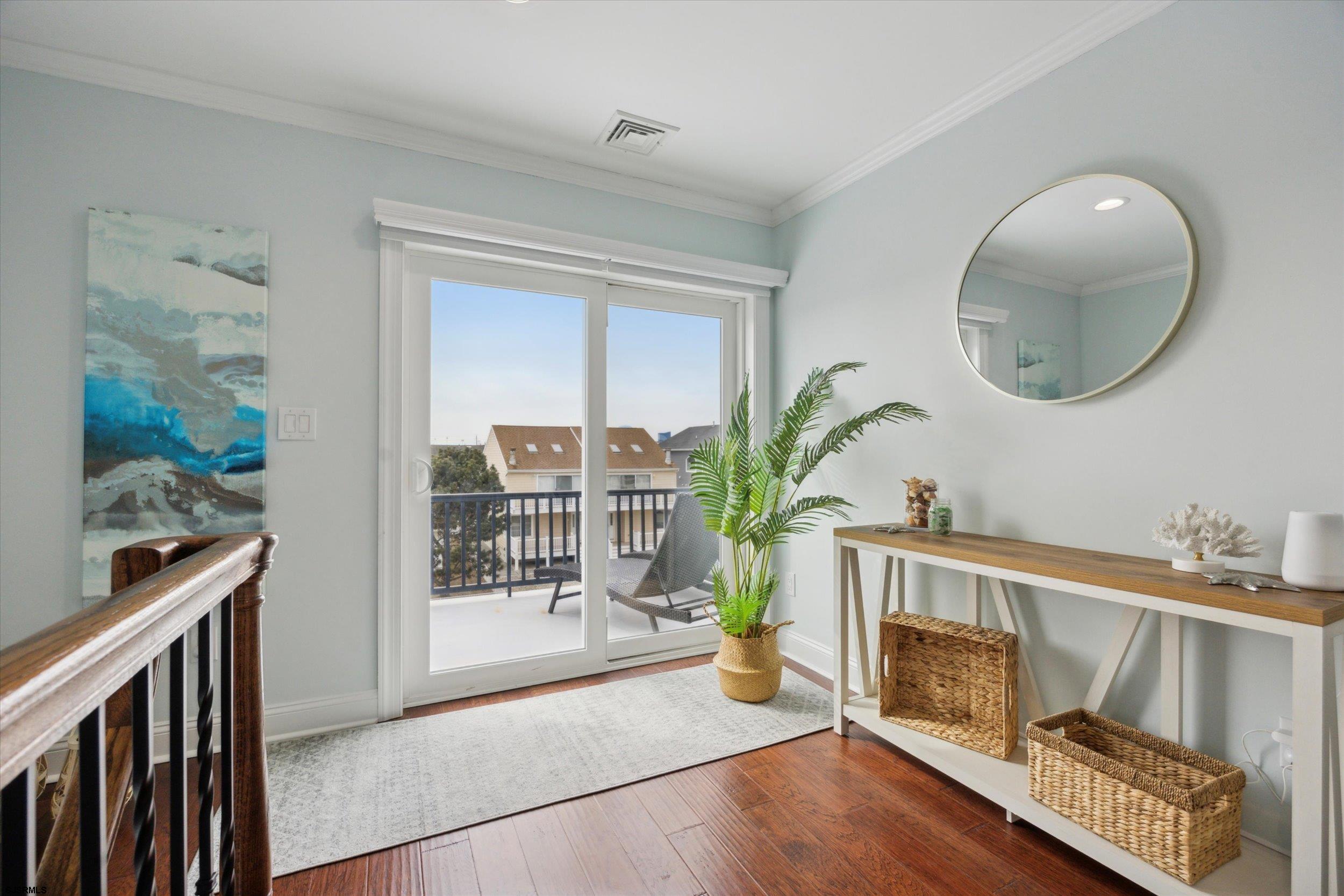 235 35th Street South Brigantine, NJ 08203 - Photo 31 of 56 a living room with a mirror and a wooden floor