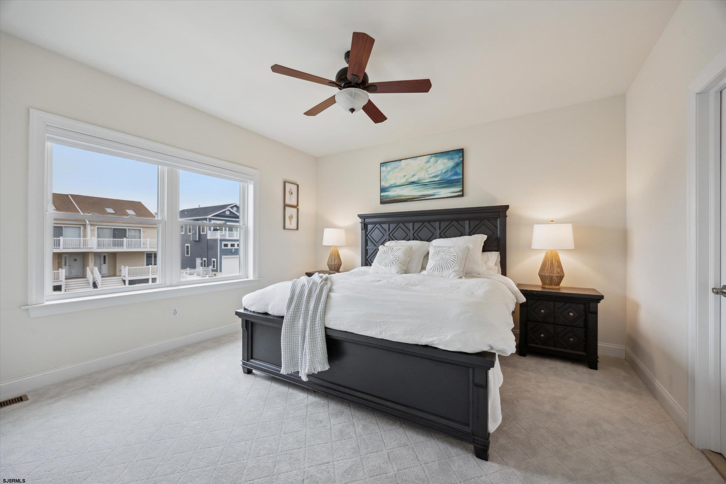 235 35th Street South Brigantine, NJ 08203 - Photo 7 of 56 a bedroom with a bed and window
