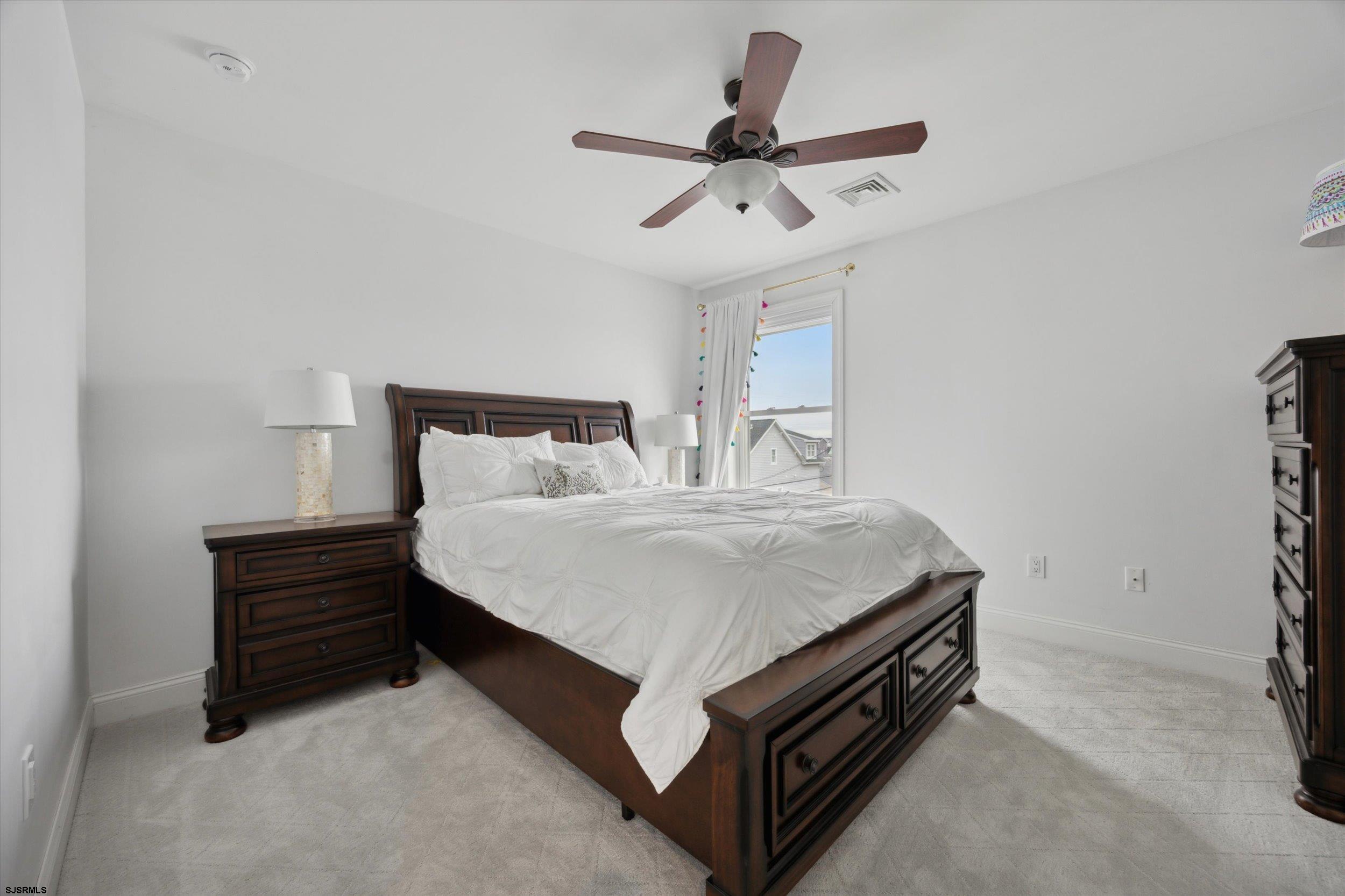 235 35th Street South Brigantine, NJ 08203 - Photo 8 of 56 a bed room with a bed and a ceiling fan