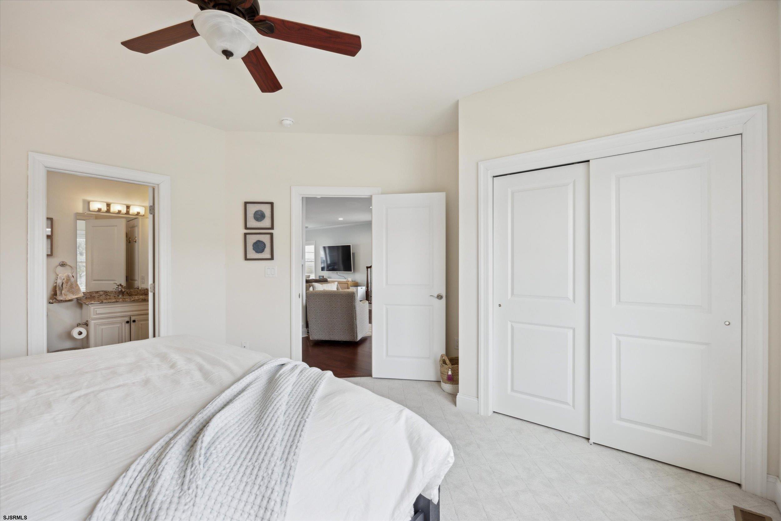 235 35th Street South Brigantine, NJ 08203 - Photo 9 of 56 a bedroom with a bed and view of bathroom