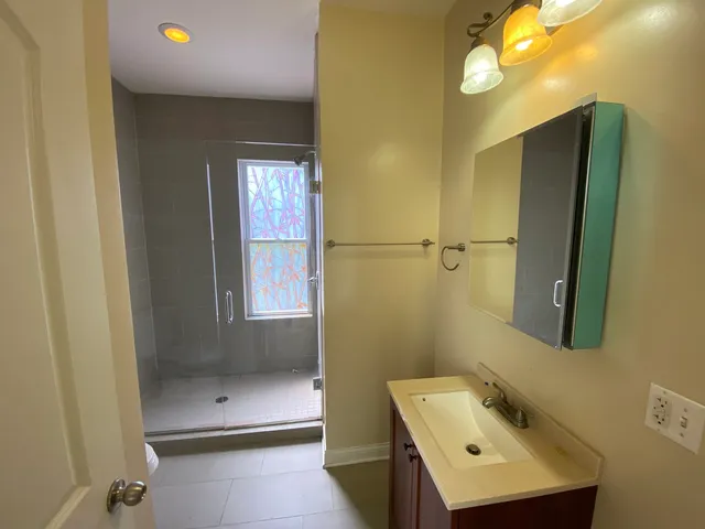 a bathroom with a sink a toilet and a mirror