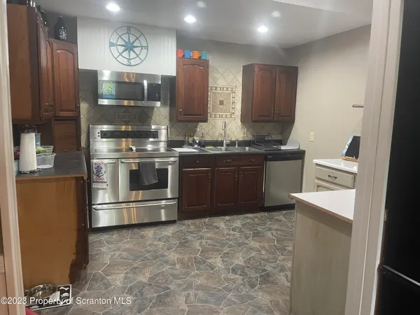 a kitchen with stainless steel appliances granite countertop a stove and a refrigerator