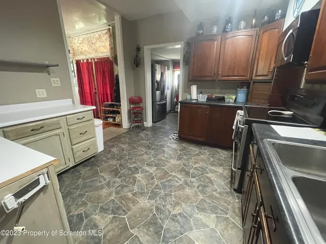 a kitchen with a refrigerator sink and cabinets
