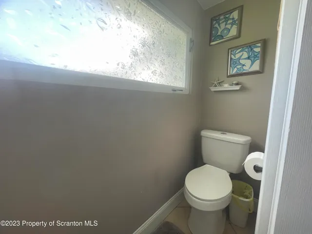 a white toilet sitting next to a window