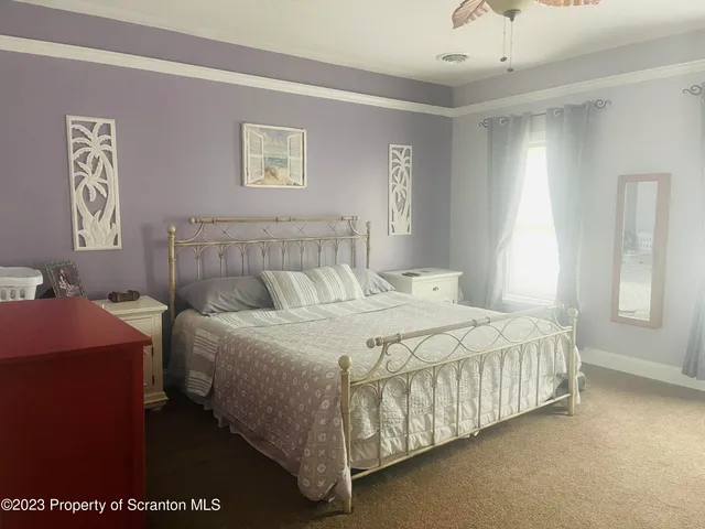 a bedroom with a bed and window