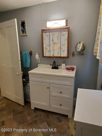 a bathroom with a sink toilet and window