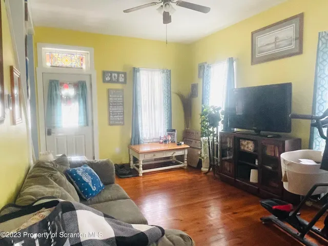 a living room with furniture and a flat screen tv