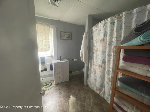 a backyard of a house with a yard and outdoor seating