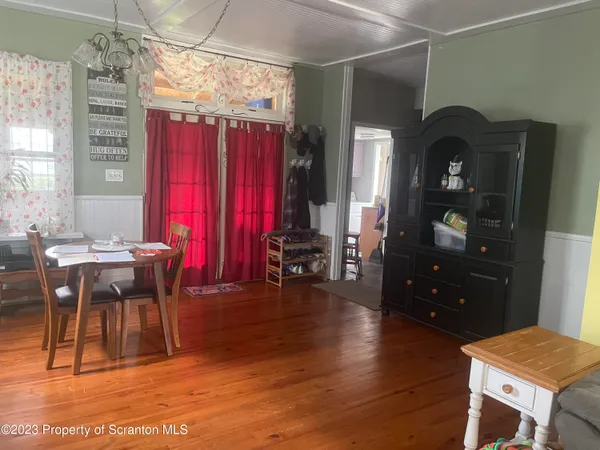 a view of a dining room with furniture and chandelier