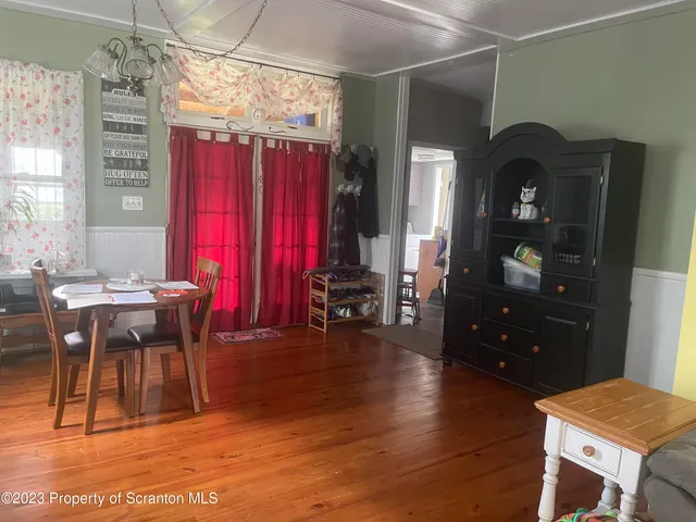 a view of a dining room with furniture and chandelier