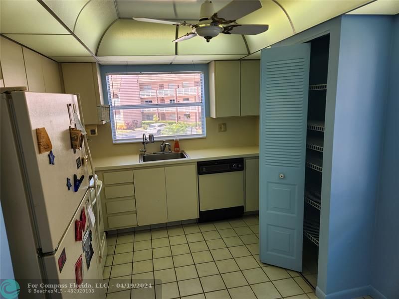 a kitchen with a sink a refrigerator and washer