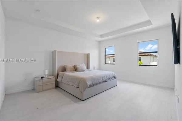 a spacious bedroom with a bed and a window