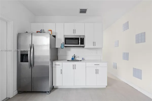 a kitchen with stainless steel appliances a refrigerator a stove a microwave and cabinets