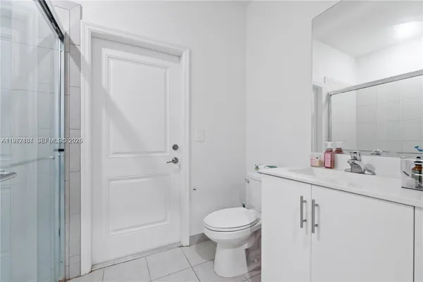 a bathroom with a toilet a sink a vanity and window