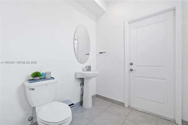 a bathroom with a sink toilet and a mirror