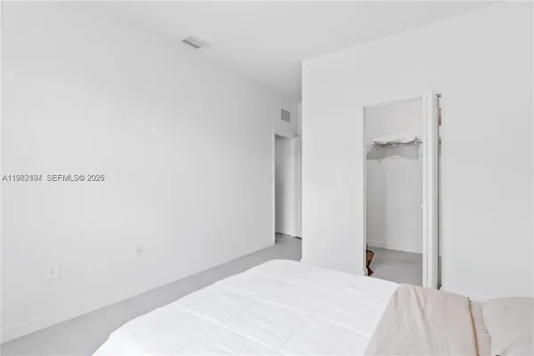 a bedroom with a bed and a lamp