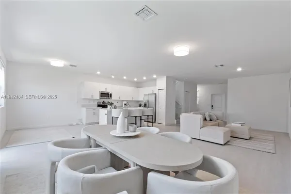 a kitchen with a dining table and chairs