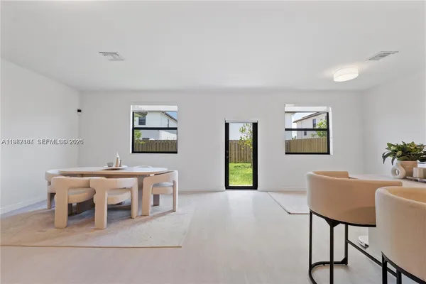 a dining room with a wooden table and chairs