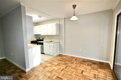 4114 Davis Place Northwest, Unit 210 Washington, DC 20007 - Photo 9 of 19 a kitchen with white cabinets and appliances