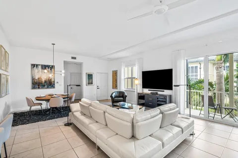 a view of a hallway with wooden floor and a living room