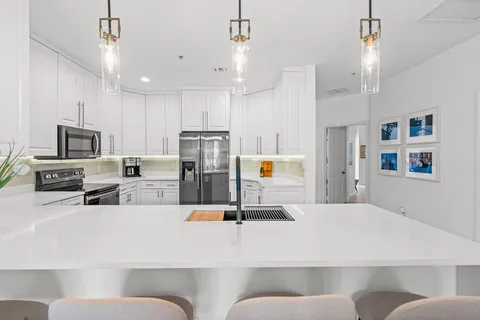 a spacious bathroom with a granite countertop sink a toilet a mirror and bathtub