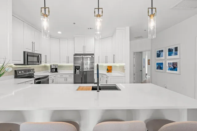 a spacious bathroom with a granite countertop sink a toilet a mirror and bathtub