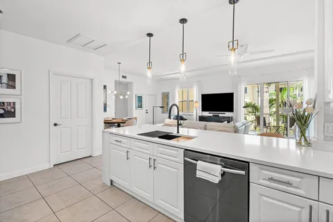 a bathroom with a granite countertop sink a mirror and shower