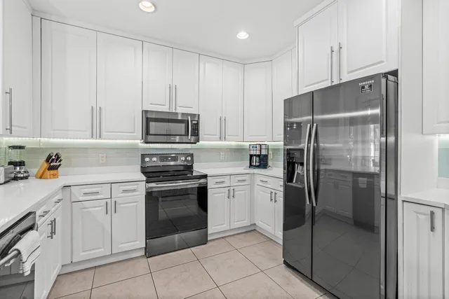 a view of walk in closet with clothes