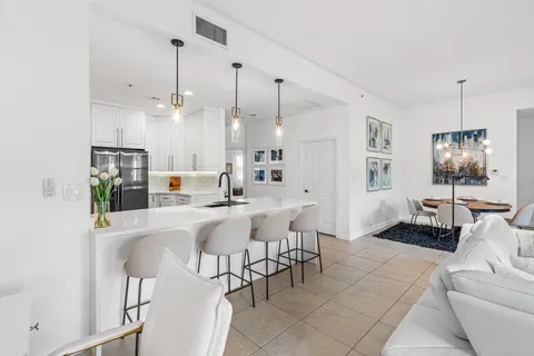 a kitchen with kitchen island white cabinets appliances and a sink