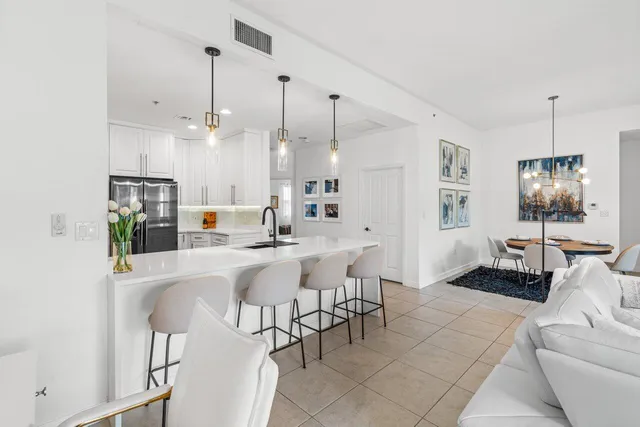 a kitchen with kitchen island white cabinets appliances and a sink