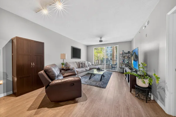 a living room with furniture and a wooden floor