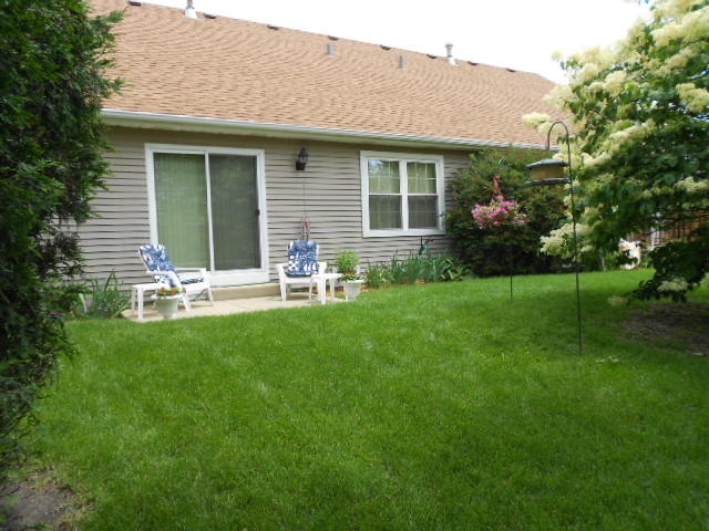 454 Prairieview Drive Oswego, IL 60543 - Photo 12 of 14 a front view of house with a garden and patio