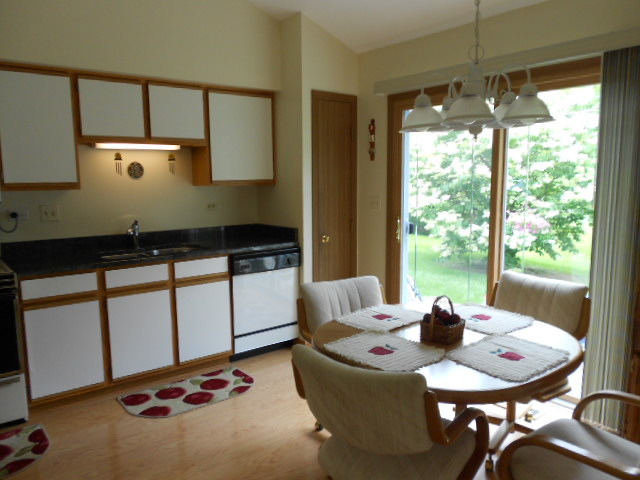 454 Prairieview Drive Oswego, IL 60543 - Photo 5 of 14 a kitchen with a table chairs and stove